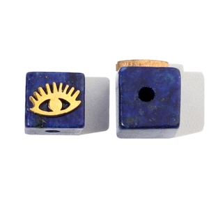 Macro detail of blue lapis lazuli square bead with golden eye pattern for DIY jewelry