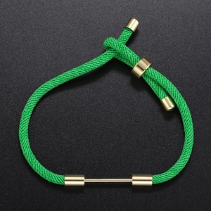 Macro detail of green braided DIY bracelet with adjustable gold metal slide clasp