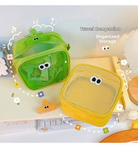Detail view of mesh organizers with large eye decorations in neon green and yellow