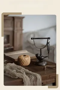 Detail of vintage cast iron bird twine holder with jute rope and rustic scissors