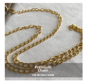 Close-up of premium gold metal chain strap with polished finish for crossbody bags