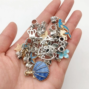 Selection of silver and gold charm pendants with blue enamel for DIY jewelry making