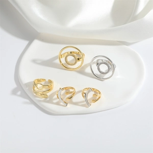 Five-piece set of geometric golden and silver rings with subtle sparkling crystal accents