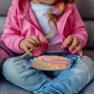 Child playing with a colorful silicone sensory activity board logic maze toy at home