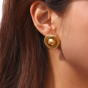 Detailed close-up of a vintage 18K gold plated twisted rope button earring on a model