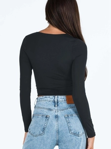 Rear view of long sleeve cropped black top with high quality fabric texture and fit