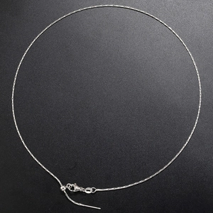 Detail of silver snake bone necklace featuring a secure lobster clasp and adjustable chain