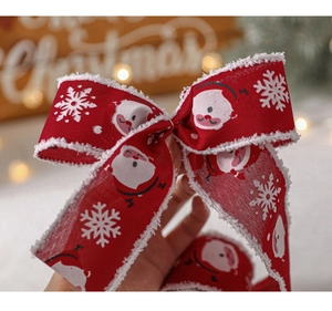 Detail of red plush Christmas ribbon with Santa Claus and snowflake patterns