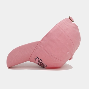 Detail of pink cotton baseball cap with blue letter embroidery and metal buckle