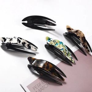 Detailed top view of five matte butterfly hair claws in various elegant patterns and colors