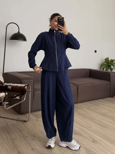 Navy blue two-piece set featuring slim-fit zip hoodie with peplum hem and wide-leg pants