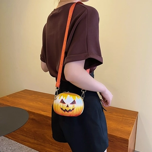 Orange pumpkin-shaped round crossbody bag with adjustable strap worn by model
