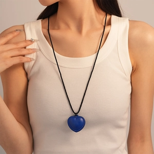 Long faux leather necklace with dark blue heart pendant on black braided cord
