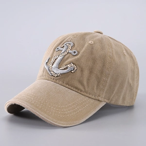 Detailed close-up of tan cotton baseball cap featuring embroidered anchor and rope pattern
