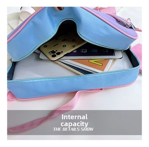 Internal view showing spacious storage capacity of the colorful canvas JK messenger bag