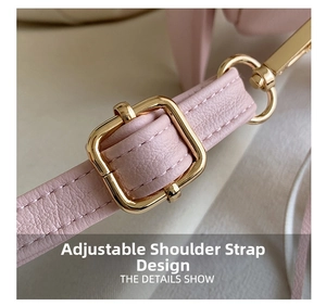 Detail of adjustable pink leather shoulder strap with gold-tone metal buckle