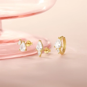 Detailed view of S925 silver gold-plated stud earrings and cuff with drop-shaped crystals