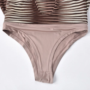 Detail of knit halter dress showing striped mesh texture and high-cut seamless hem