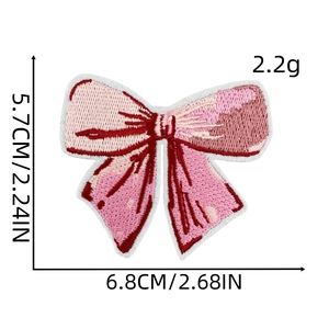 Detail view of pink bow embroidery patch with precise dimensions and 2.2g weight