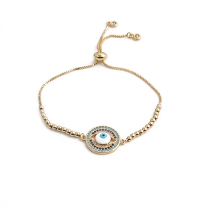 Detailed view of the Evil Eye charm on a gold-plated adjustable bracelet with blue stones