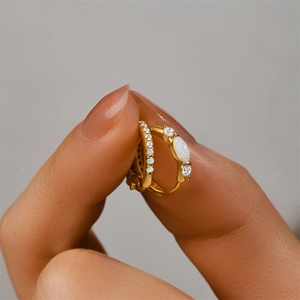 Detailed hand-held view of S925 silver gold-plated hoop earrings with opal and zircon