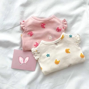 Close-up of pink and beige pet vests with floral rabbit prints and ruffle sleeves