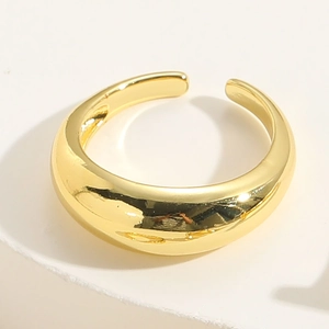 Polished gold adjustable open ring with a smooth mirror finish on a white pedestal