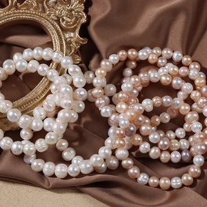 Lustrous white and pink freshwater pearl bracelets on brown silk with vintage frame