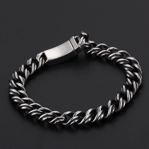 Macro view of 316L stainless steel Cuban link bracelet with engraved metal buckle detail