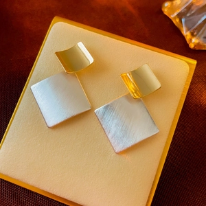 Minimalist geometric square stud earrings in polished gold and brushed silver metal finish