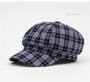Detail of navy blue plaid octagonal newsboy hat with textured cotton fabric