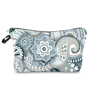 Detail of blue and grey paisley fabric makeup bag showing black zipper and side handle