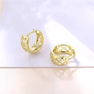 Elegant gold clover hoop earrings with hollow floral design in a minimalist style