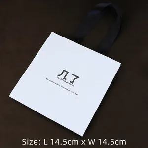 White square jewelry gift bag with black silk ribbon handles and size 14.5x14.5cm