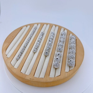 Detailed comparison of five sizes of silver cubic zirconia spacers on a wooden display tray
