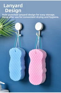 Macro detail of bath sponges with fish scale texture and hanging rope on wall hooks
