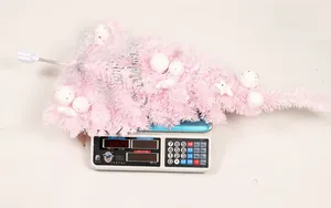 Pink PVC Christmas teardrop tree with Merry Christmas sign weighing 420g on scale