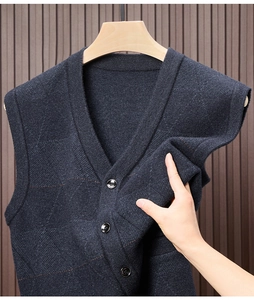 Close-up of navy blue knit vest showing flexible fabric texture and button details