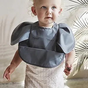 Waterproof baby silicone bib with 3D wing design and deep food catcher pocket in dark grey