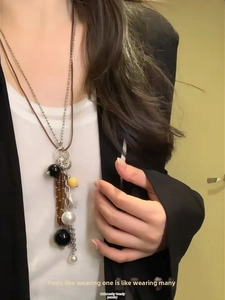 Detail of vintage layered brown leather necklace with silver shells and beads