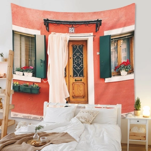 Detail of Mediterranean wall tapestry showing an orange wall, blue shutters, and flowers