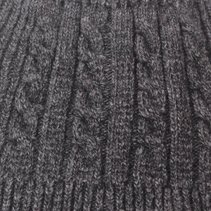 Detailed close-up of dark grey cable knit wool beanie with thick ribbed texture