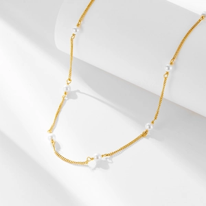 Elegant s925 silver gold pearl choker necklace displayed on white geometric props