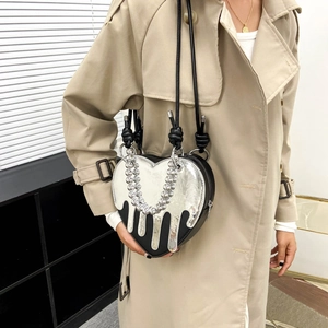 Silver metallic heart crossbody bag with fluid drip detail and black leather strap