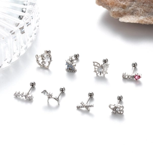 Macro shot of 8-piece silver stainless steel cartilage earrings set with zircons and screw backs