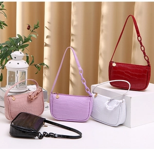 Detailed display of crocodile pattern hobo bags in red pink purple white and black colors
