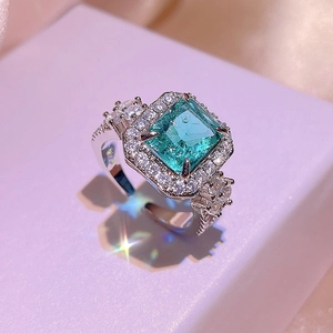Princess-cut paraiba tourmaline zircon ring with halo pavé setting in silver finish