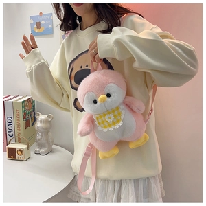 Front view of cute pink penguin plush backpack with yellow plaid bib worn by a model