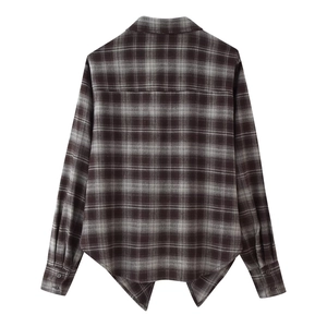 Detail view of the back of a vintage plaid shirt featuring brown and grey knit textures
