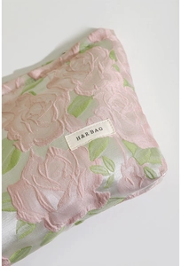Détail du tissu jacquard floral et étiquette H&R BAG sur cette trousse de toilette